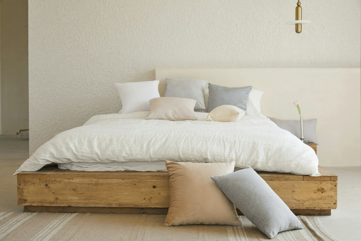 Natural linen bedding on wooden bed frame
