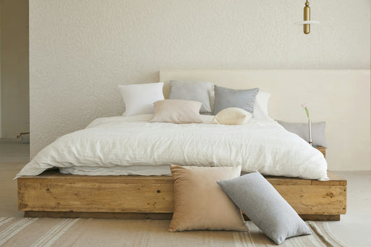 Natural linen bedding on wooden bed frame