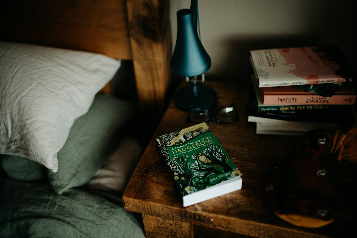 Styled bed with books and lamp